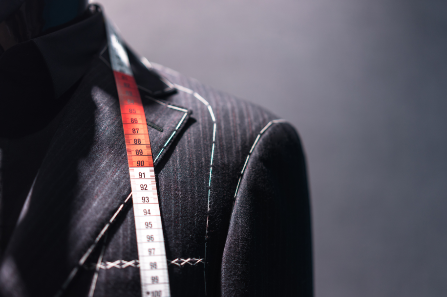 tailor-cutting-measuring-bespoke-suit-not-one-size-fits-all-marathon-recovery-blog